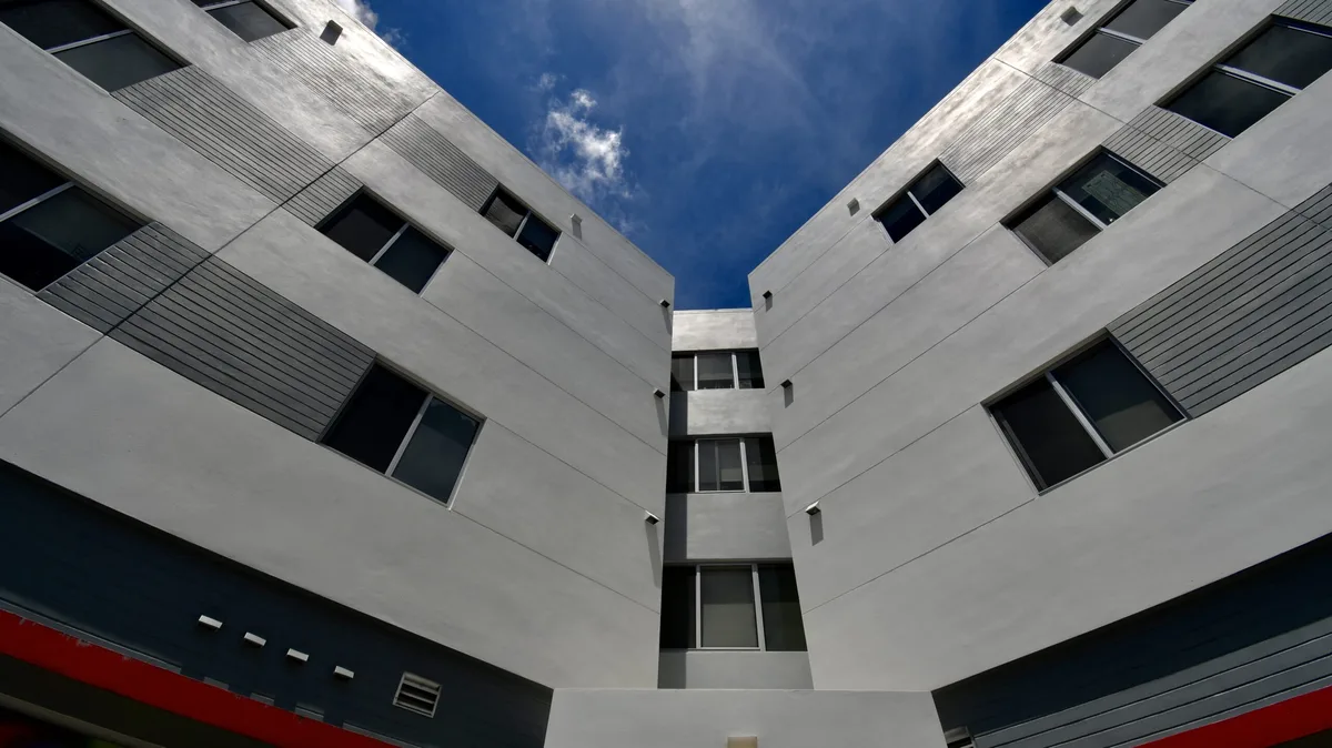 White condominium courtyard exterior after repaint
